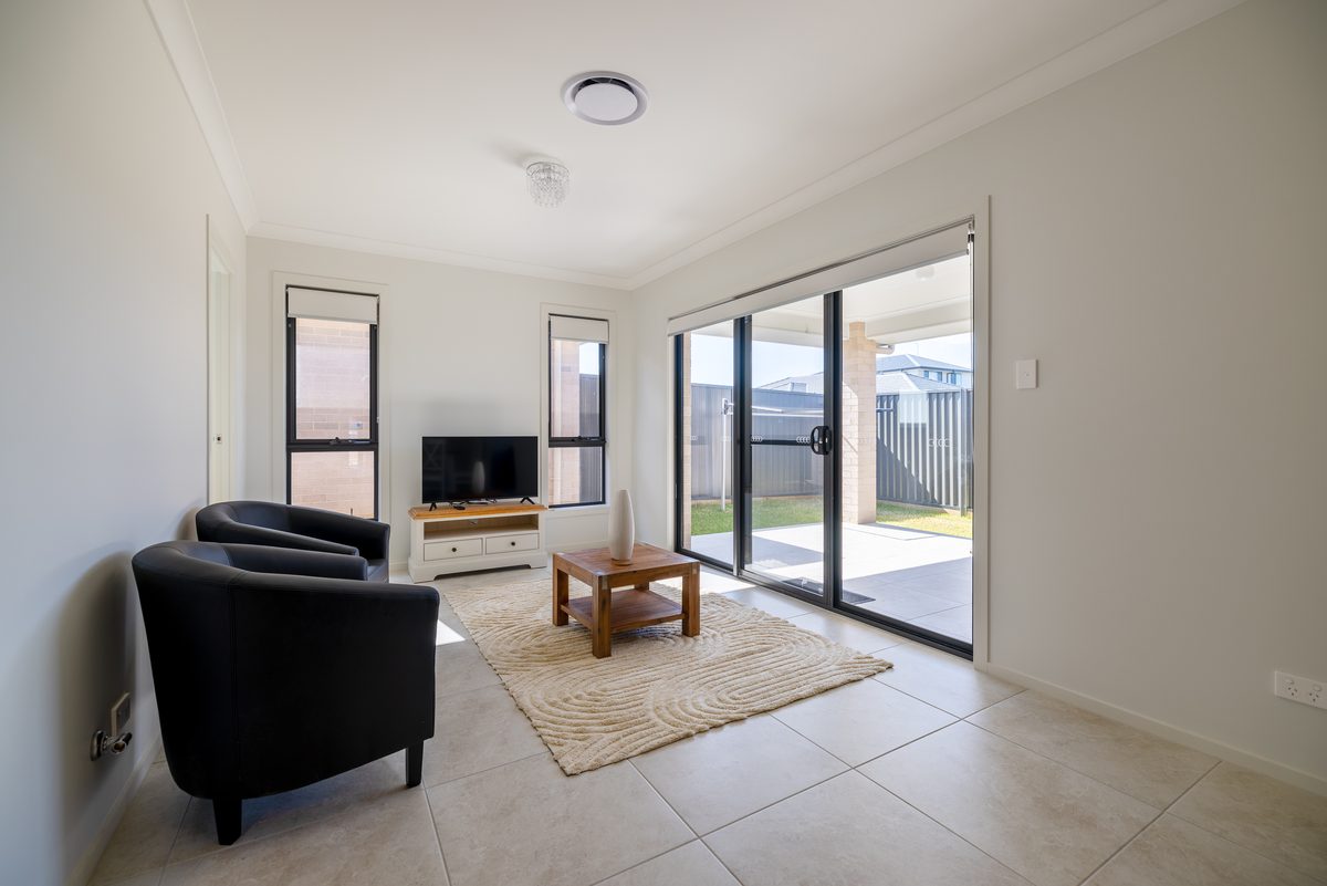 Living room opening to the backyard in a Spring Farm ASDA home